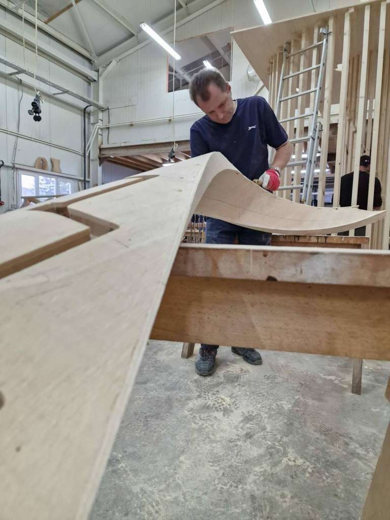 Apex craftsman carving a bespoke Georgian staircase component.