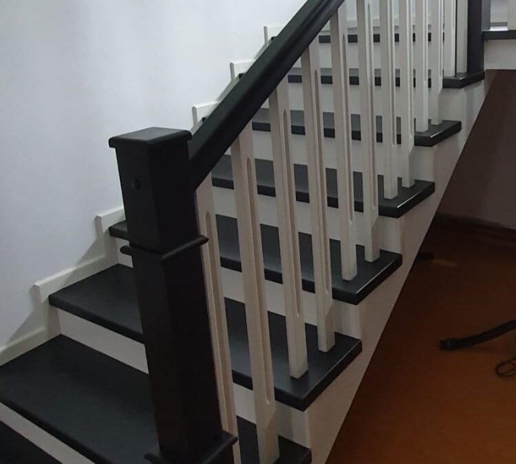 New modern staircase with Victorian-inspired balustrade and oak handrail by Apex Staircases.