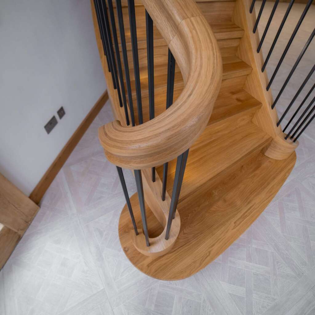 Turned wooden balusters and curved handrail of a Georgian staircase.