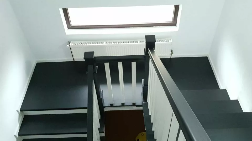 Modern Victorian staircase with oak treads and painted white risers by Apex Staircases.