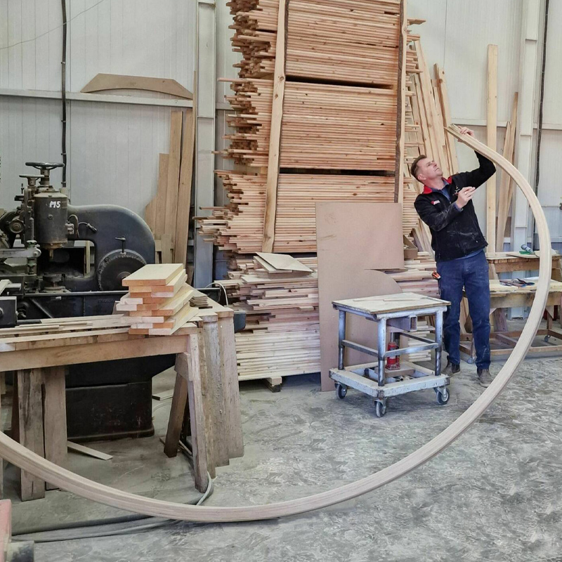 Handmade helical staircase by Apex Staircases, UK. Bespoke walnut and glass curved design, manufactured in Britain.